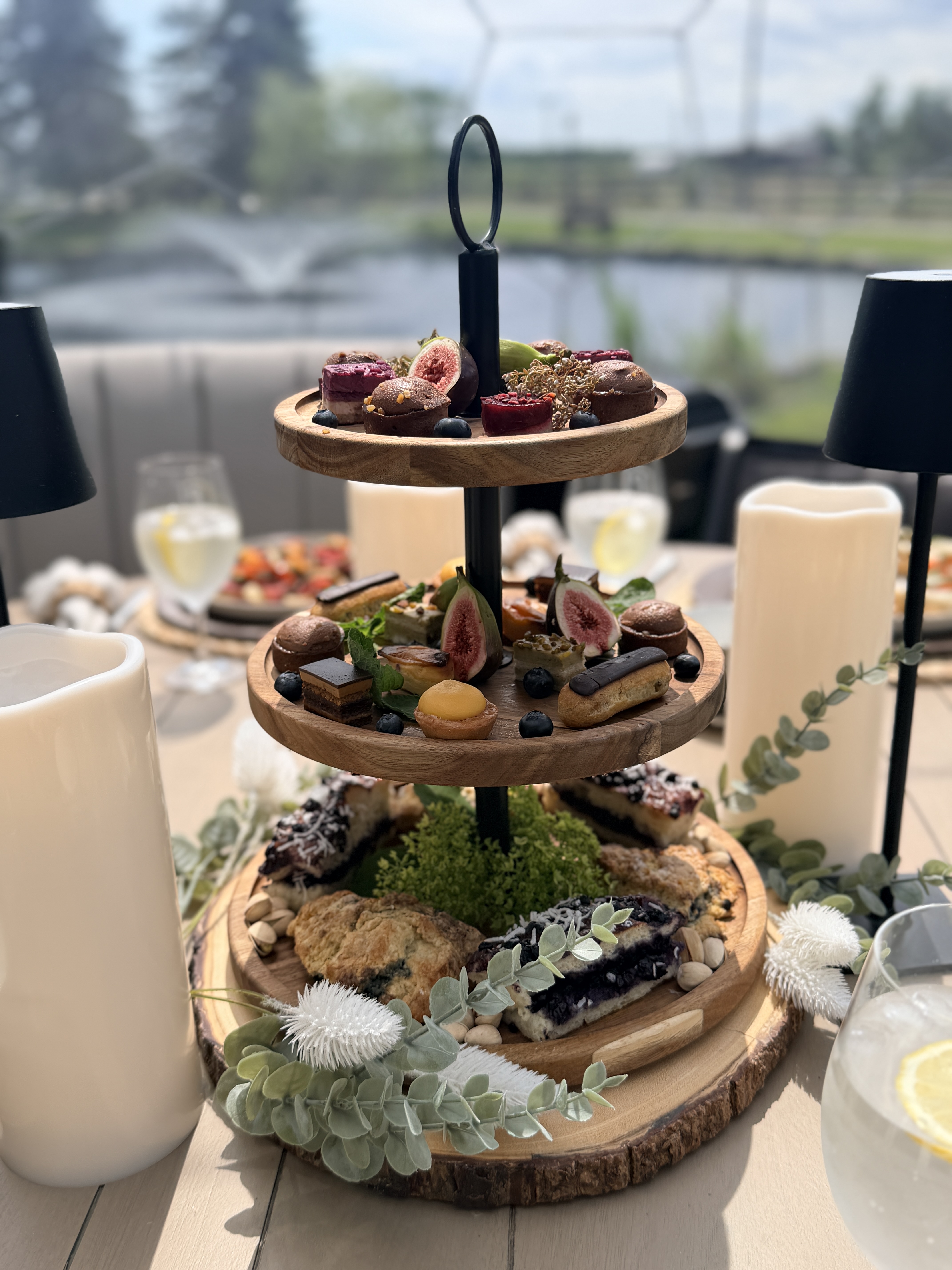 Tiered dessert stand with fig, macarons and pastries