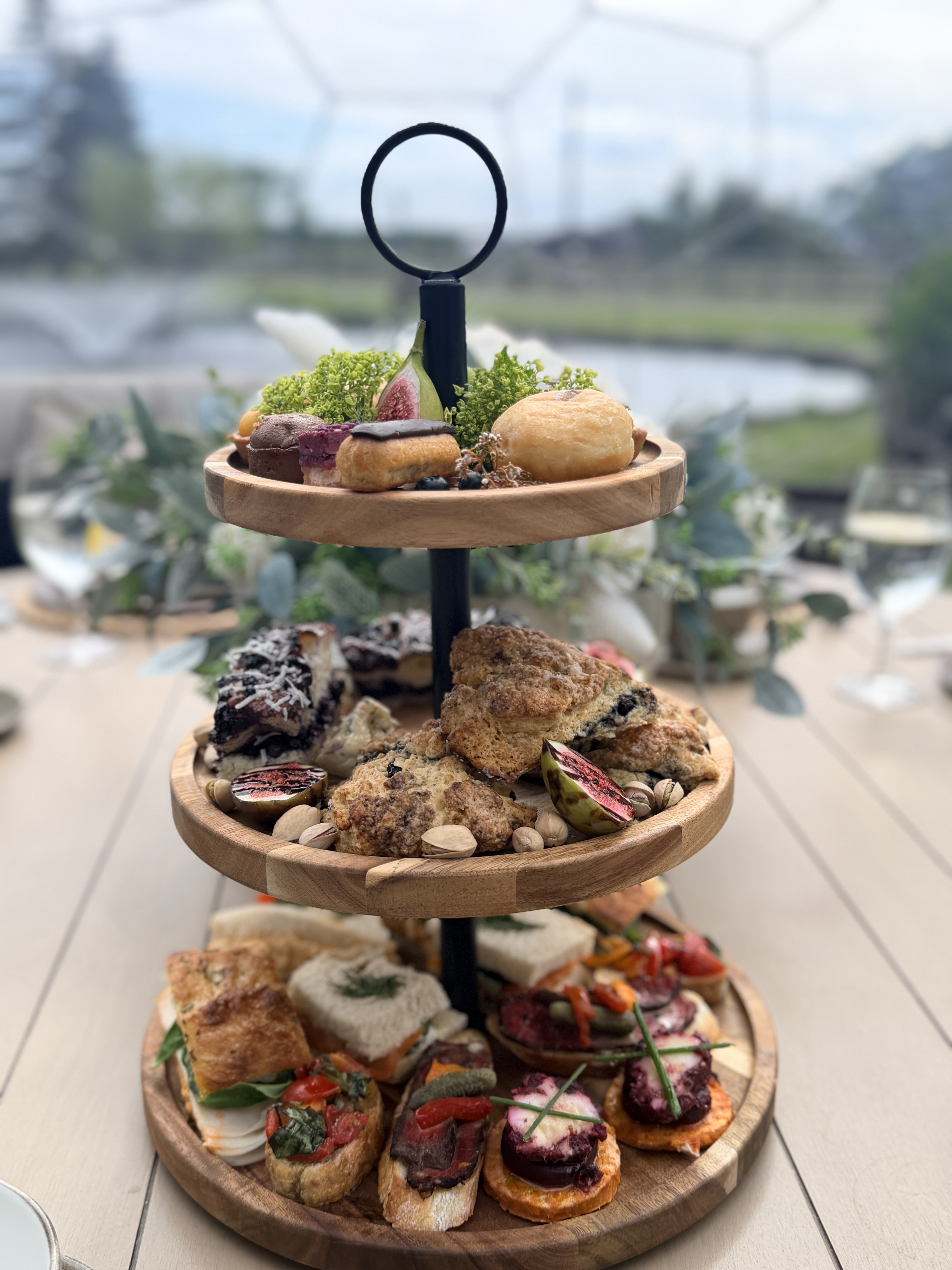 Tea tower with scones, figs and pistachios by the pond