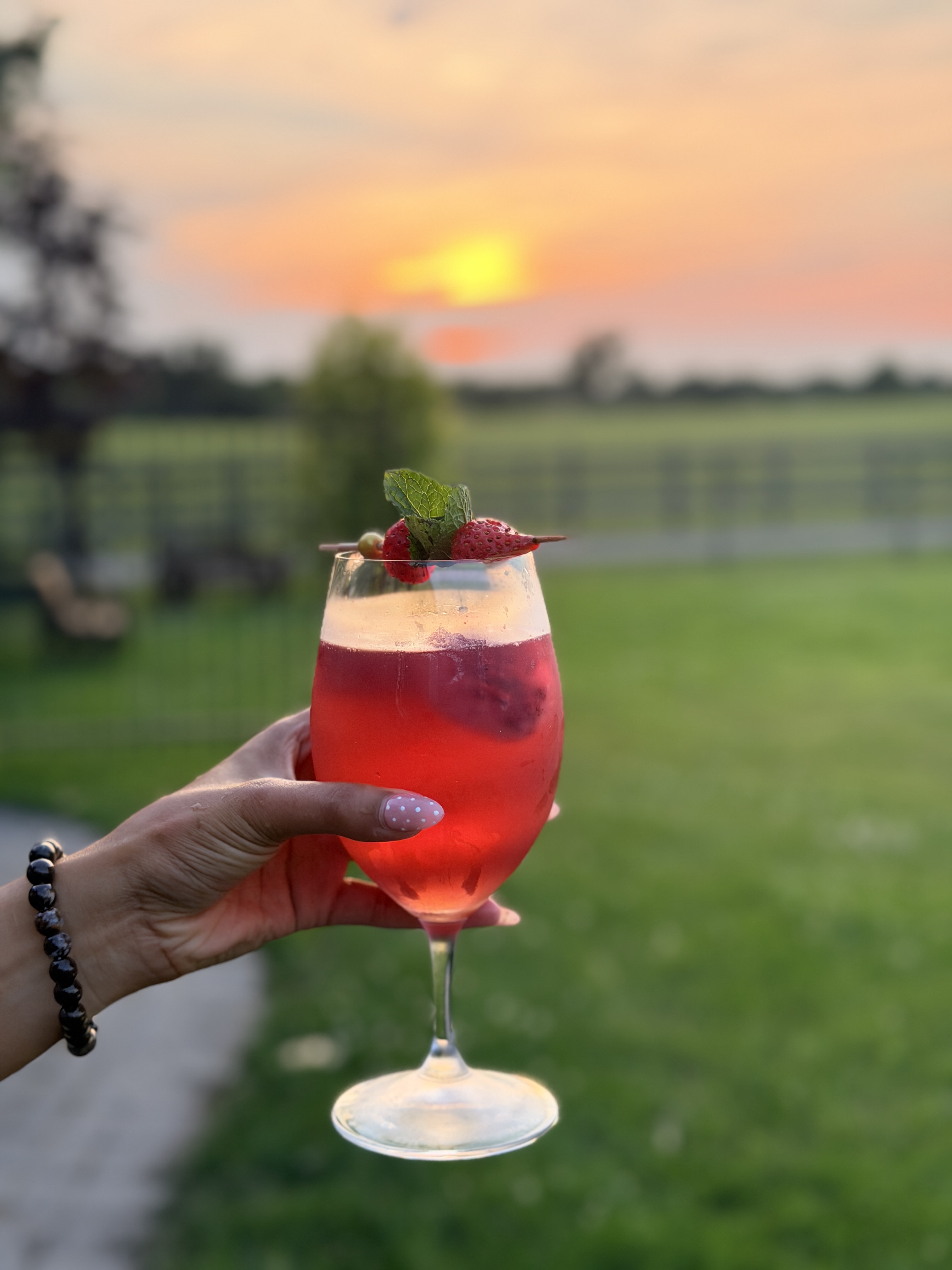 Toasting a cocktail outdoors at golden hour