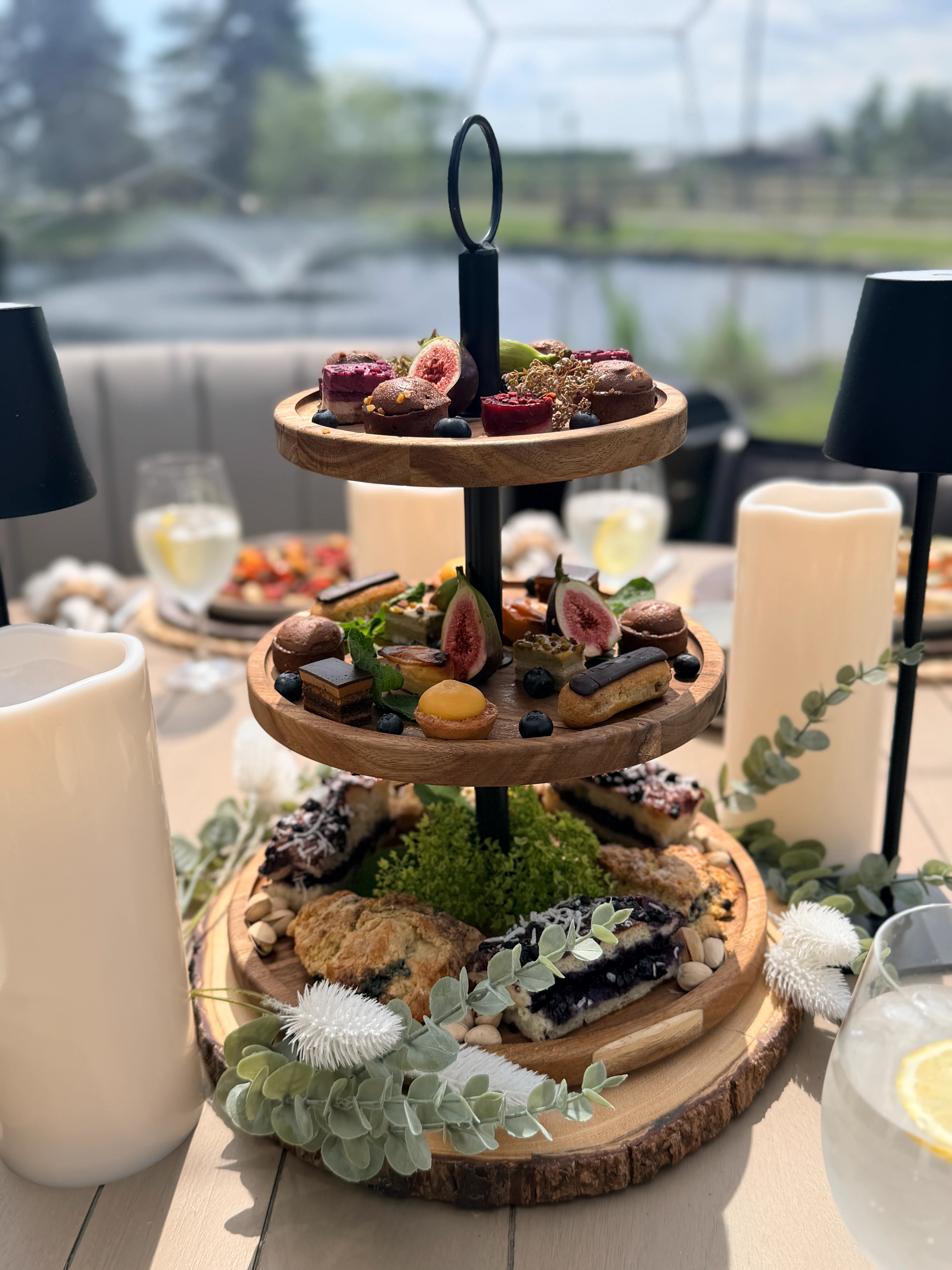Tiered afternoon tea tower with figs, macarons and pastries